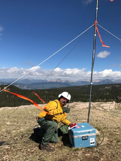 Communications Technician Brad Nelson performs maintenance on an overland network repeater, one of 10 on high locations that keep firefighters in contact with eachother as they battle the 416 Fire.