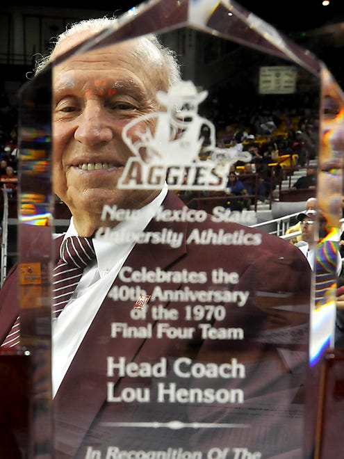 Sun-News photo by Norm Dettlaff
Former New Mexico State University men's basketball coach Lou Henson looks at his award Saturday at the Pan American Center. He was recognized for the 40th anniversary of reaching the final four in 1970.