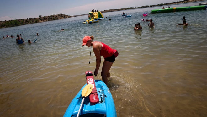 Lifeguard Emilee Lucero prepare for her patrol in her kayak June 26 at the Beach at Farmington Lake.