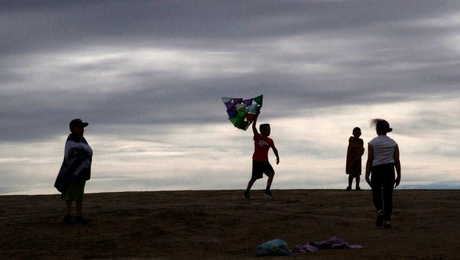 Spring Fling participants launch a kite, Tuesday, March 22, 2016 at Farmington Lake.