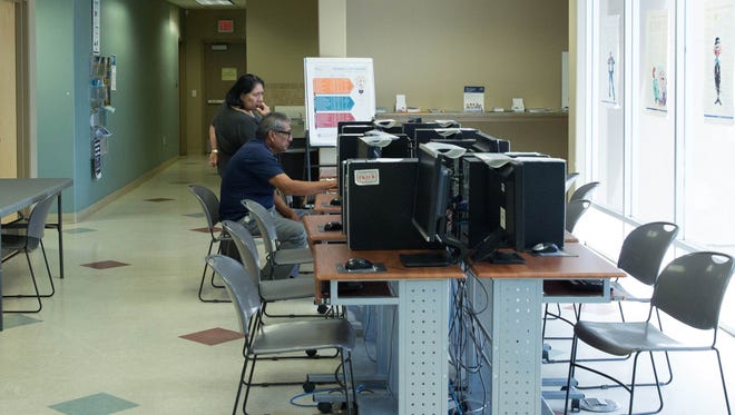 Job seekers work at computers in the New Mexico Workforce Connection office in Las Cruces in September 2017.