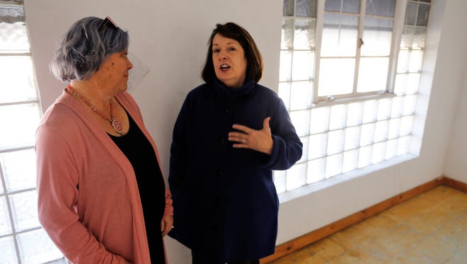 Karen Ellsbury, left, and Ronna Jordan tour the upstairs space at 305 W. Main Street that soon will serve as the offices of Jordan's Houses for Hope nonprofit organization.