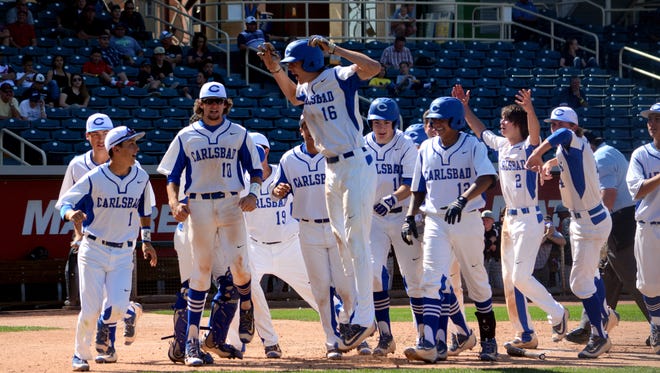 Carlsbad celebrates a two-run home run by Trevor Rogers (16) Friday against Volcano Vista.