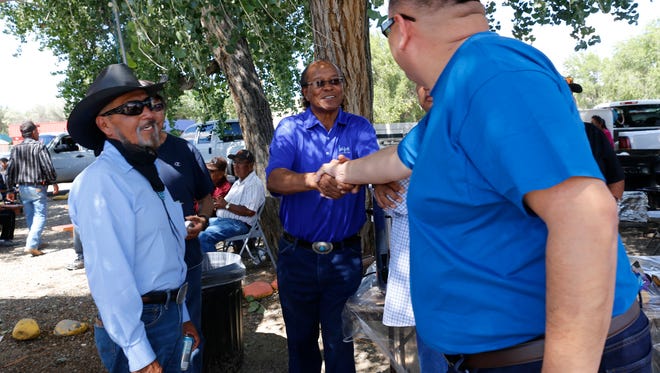 Shiprock Chapter President candidate Donald Benally shakes hands with voters, Tuesday, Aug. 30, 2016 at the Shiprock Chapter House. At left, is Shiprock Chapter President candidate William Lee.