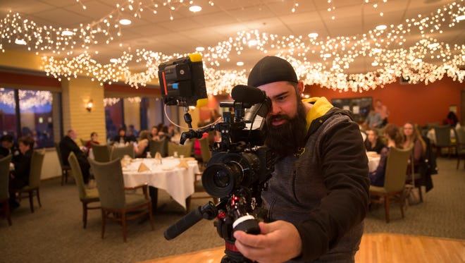 Director Brent Garcia frames a shot during the filming of "Aurora's Law" on Wednesday at the San Juan Country Club in Farmington.