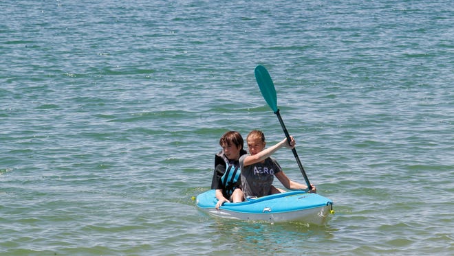 Matthew Brown and Megan Brown ride their kayak, Friday, May 18, 2018 on Farmington Lake.