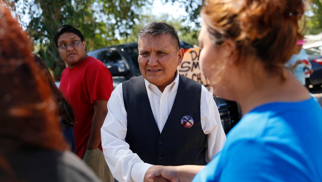 Shiprock Chapter president candidate Dan Smith shakes hands with voters, Tuesday, Aug. 30, 2016 at the Shiprock Chapter House.
