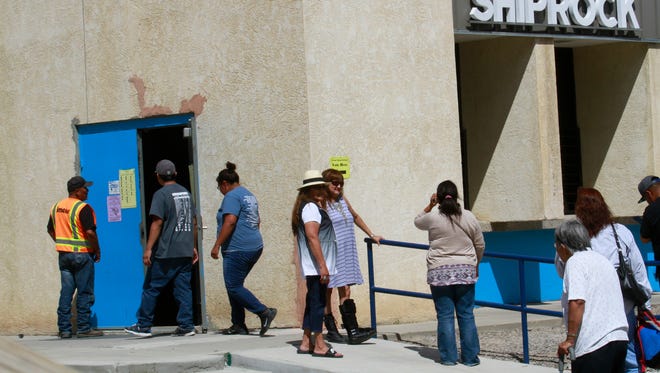 Voters line up Tuesday to take part in the Navajo Nation primary elections at the Shiprock Chapter house.