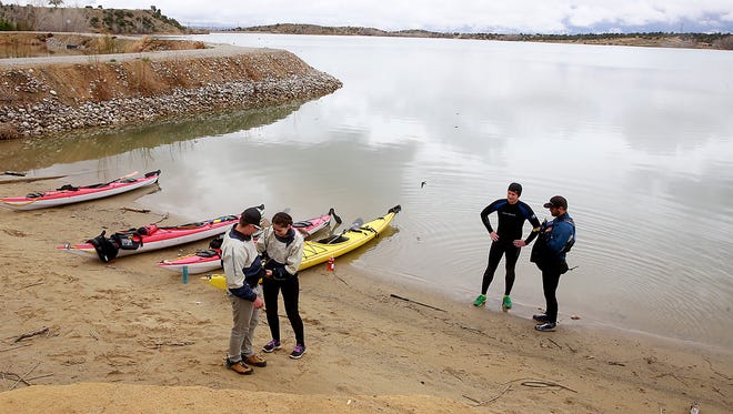 From left: Ethan Martin, Eliza Thurston, Nathan Henkenius and Scott Burchfield break for lunch while kayaking on Saturday April 16, 2016, at Lake Farmington.
