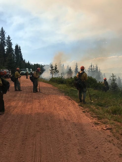 Hotshot teams are seen starting fire operations in Division H on the southwest edge of the 416 Fire in this undated photo as crews work to burn underbrush ahead of the fire ' s advance.