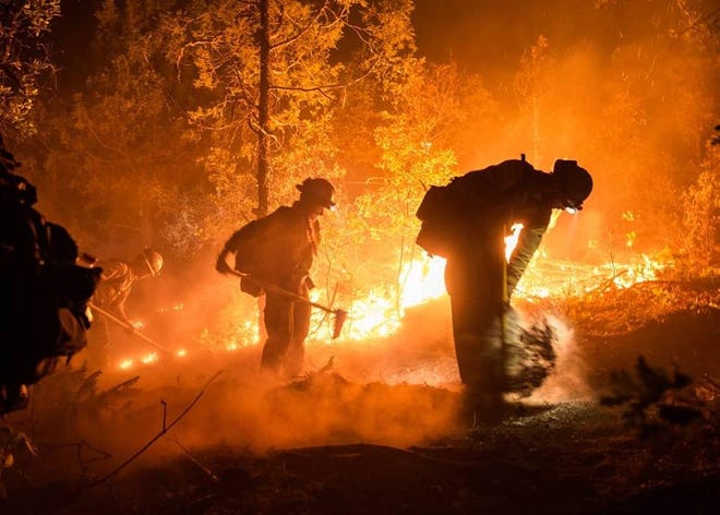 Firefighters from the Los Pinos Fire Protection District of Ignacio, Colorado, battle 416 Fire flames over the weekend in this undated photo provided by the San Juan National Forest. The image was captured by a firefighter from Wyoming.