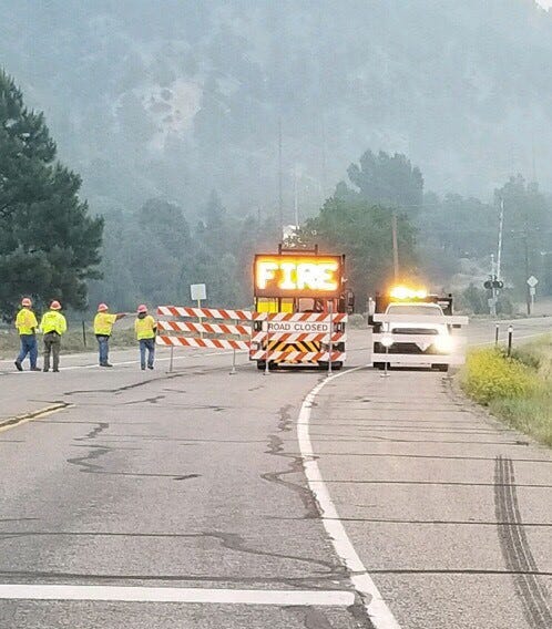 A Colorado Department of Transportation maintenance crew moves barriers from the upper County Road 250 area to the location of where the train tracks cross U.S. Highway 550 in Hermosa, Colo.