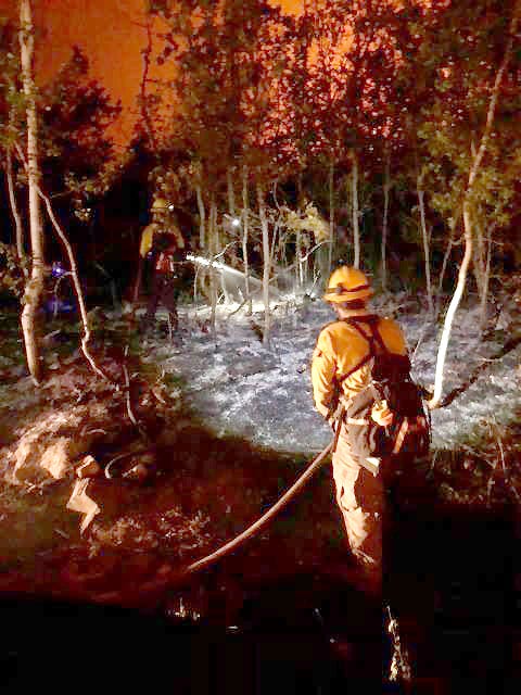 This undated photo of firefighters battling the 416 Fire near Durango, Colorado, is part of a gallery posted by the #416 Fire team at http://bit.ly/2JpxhQG.