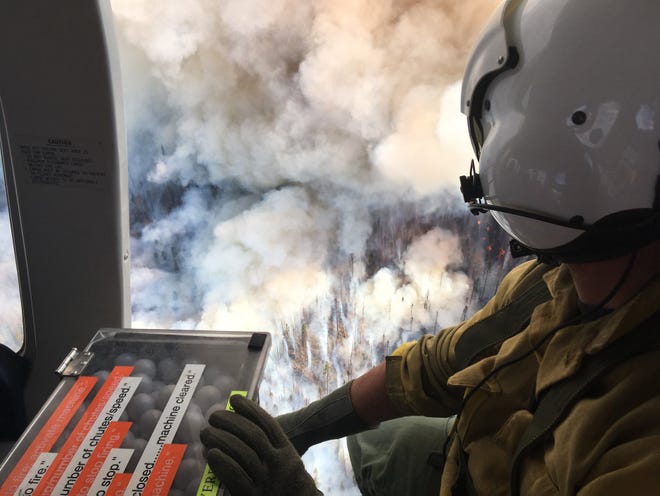 Firefighters used flammable plastic spheres dropped from helicopters yesterday to set backfires in the Clear Creek area the 416 Fire Division H zone on the western edge of the fire.