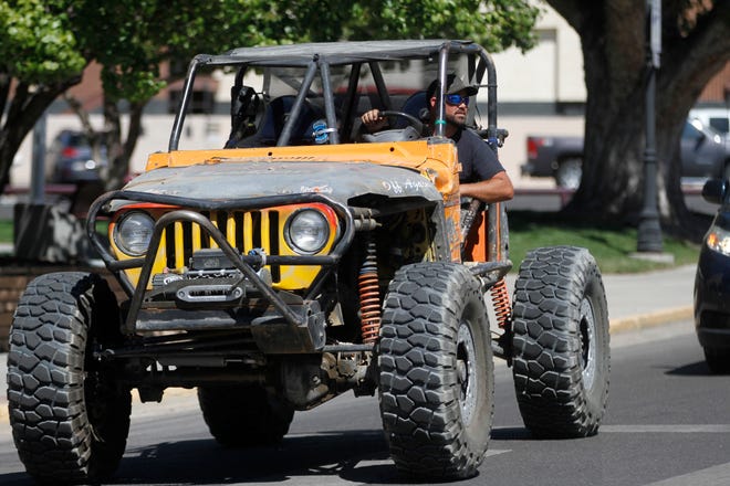Rick Jenkins drives his 2000 Jeep Wrangler named "Cheeto"through the intersection of North Orchard Avenue and West Main Main Street, Friday, Sept. 7, 2018 to join friends during a lunch event for the Four Corners 4x4 Week in Farmington.