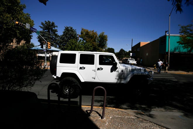 A driver of a  Jeep Rubicon searches for a parking spot near the Three Rivers Brewery, Friday, Sept. 7, 2018 during a lunch event for the Four Corners 4x4 Week in Farmington.
