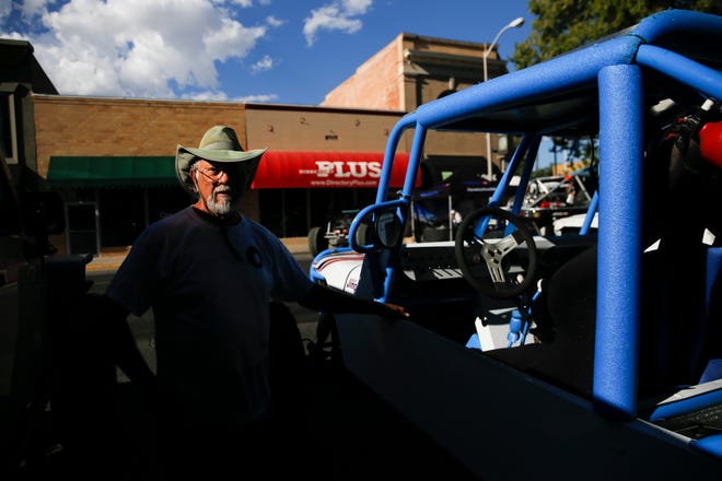 Cliffhangers 4-Wheel Drive Club member Doug Loyd shows off his 4-wheel drive vehicle named " I'm Blue Too", Friday, Sept. 7, 2018 during the Offroad Downtown Takeover along Main Street in downtown Farmington.