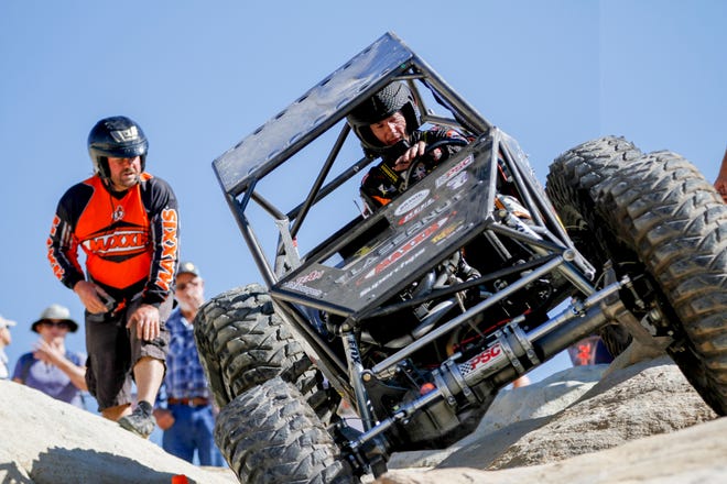 Jesse Haines, right, descends down a rock crawl area with his unlimited with the help of his spotter, Troy Bailey, Saturday, Sept. 8, 2018 during the W.E. Rock Grand Nationals at the Brown Spring Campground rock crawl in Glade Run north of Farmington.
