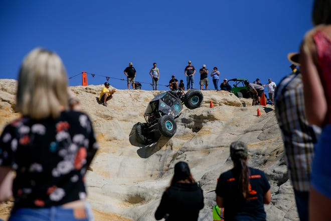 Spectators watch as Virgil Ray,Tonopah, Arizona navigates up a rock face, Saturday, Sept. 8, 2018 during the W.E. Rock Grand Nationals at the Brown Spring Campground rock crawl in Glade Run north of Farmington.