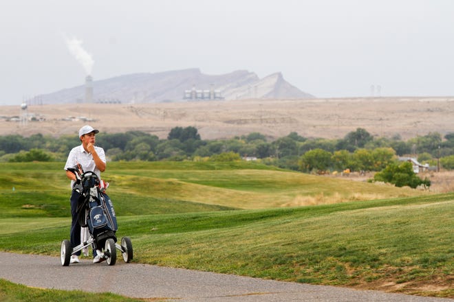 Trey Diehl walks to the next hole in October 2018 during the Chuck Soria Invitational Golf Meet at the Riverview Golf Course in Kirtland. The County Commission voted 4-1 in favor of increasing gross receipts taxes rather than cutting services, which could have meant closing the golf course.