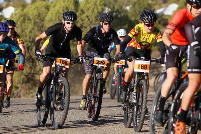Flagstaff, Arizona's Scott Keller (bib 166), Farmington's Neil Merrion (229) and Las Cruces' Tamatha Risner (169) keep pace with the group during the long-course race at the 38th annual Road Apple Rally Saturday at Lions Wilderness Park in Farmington.