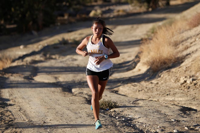 Eldorado's Jasmine Turtle-Morales  coasts up the last hill toward the finish line during the District 2-5A cross country championships Friday at Pinon Hills Community Church in Farmington. Morales won the girls race at 21:44.86.