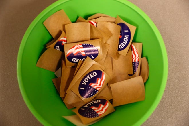 Stickers are handed out to voters, Tuesday, Nov. 8, 2016 at the Farmington Civic Center.