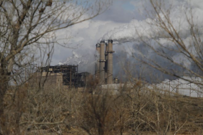 The San Juan Generating Station is pictured in January 2013 through the trees in Waterflow.