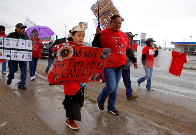 Lil Miss Northern Navajo JaiLissa Begay carries her sign on May 23, 2019 during the awareness walk in Shiprock that focused on missing and murdered Indigenous women and girls.