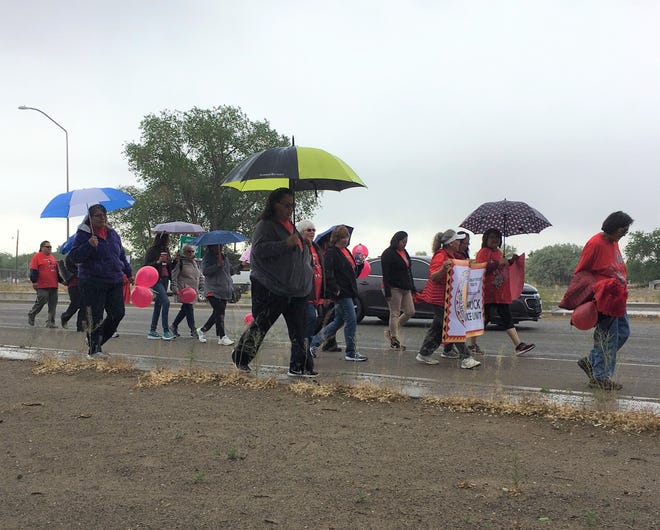 Walkers proceed along U.S. Highway 64 in Shiprock on May 23, 2019 to raise awareness about the issue of missing and murdered Indigenous women and girls.