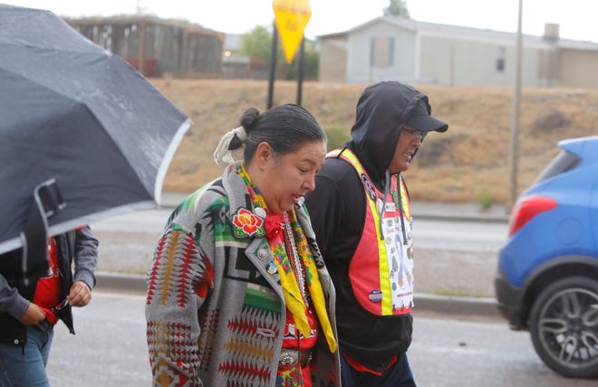Navajo Nation Council Delegate Amber Kanazbah Crotty, left, and John Tsosie, co-founder of Walking the Healing Path, walk along U.S. Highway 64 in Shiprock on May 23, 2019 to raise awareness about missing and murdered Indigenous women and girls.