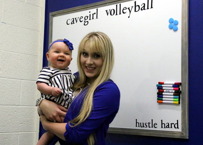 Carlsbad's new volleyball coach Hannah Hamblin and her seven-month old daughter, Bliss, pose inside Hamblin's office. Hamblin looks to revitalize a volleyball program that went 9-33 in its two previous seasons.