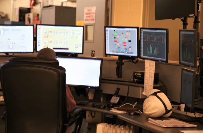 An employee watches screens inside the control room to ensure operations run smoothly at the San Juan Generating Station in this Sept. 25, 2019 file photo.