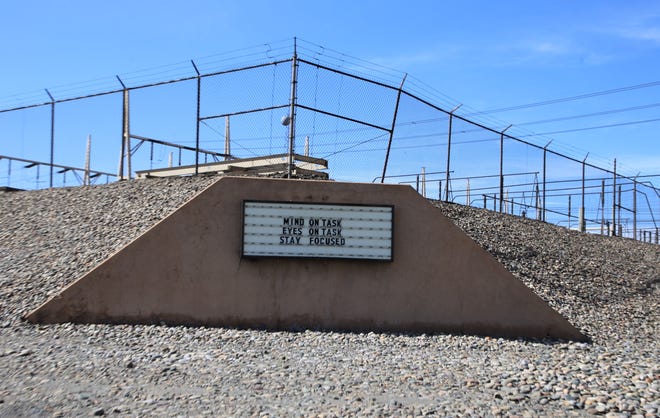 A sign outside the switch yard at the San Juan Generating Station provides a message for employees.