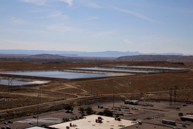 The power plant burns coal to heat water. The steam turns turbines to generate power. Once the water can no longer be used in the power plant, it is placed in evaporation ponds like those seen in this picture taken, Wednesday, Sept. 25, 2019, from the San Juan Generating Station.