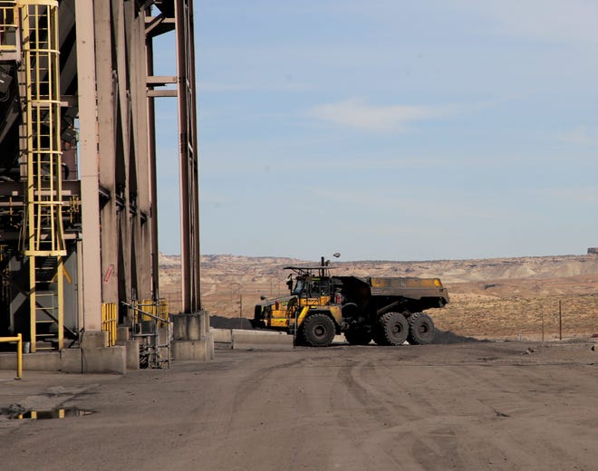 Trucks from San Juan Mine take fly ash back to the mine and place it in pits that will later be reclaimed.