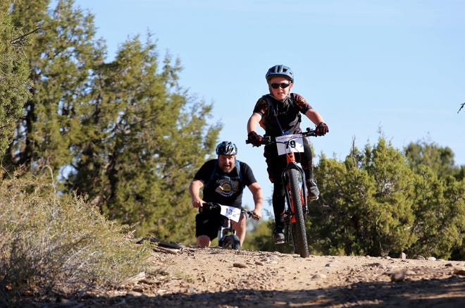Father and son duo, W. Cockrell, age 10, and William Cockrell, ride their bikes, Saturday, Oct. 6, 2019, in the Road Apple Rally's short course.