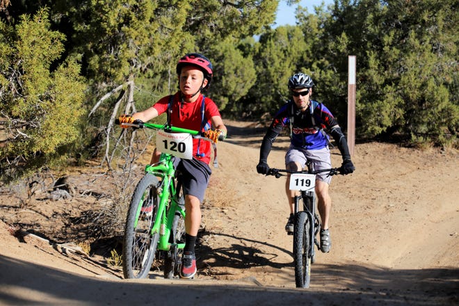 C. Smith, age 9, and Carl J. Smith ride together, Saturday, Oct. 5, 2019, during the Road Apple Rally in Farmington.