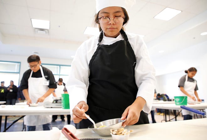 Bond Wilson Technical Center student Alexandria Heart prepares an omelet for the culinary art competition at Skills Fest on Oct. 22 at Navajo Technical University in Crownpoint.