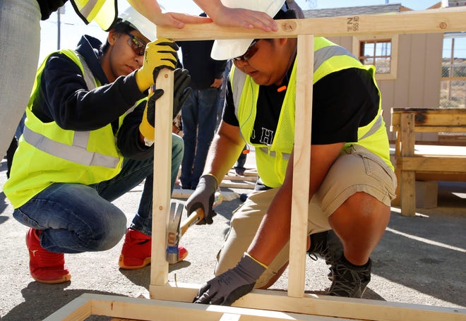 Bond Wilson Technical Center student Julius Smith uses a hammer to secure part of a dog house during the construction technology competition at Skills Fest on Oct. 22 at Navajo Technical University in Crownpoint.
