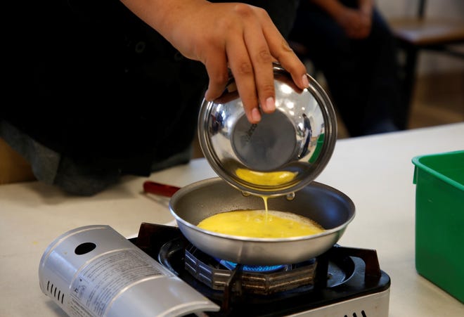 A student pours egg batter for an omelet during the culinary arts competition at Skills Fest on Oct. 22 at Navajo Technical University in Crownpoint.
