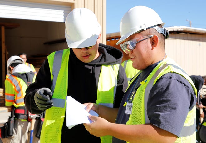 Bond Wilson Technical Center students Kenzie Cook, left, and Lance Clyde take a look at guidelines during the construction technology competition at Skills Fest on Oct. 22 at Navajo Technical University in Crownpoint.