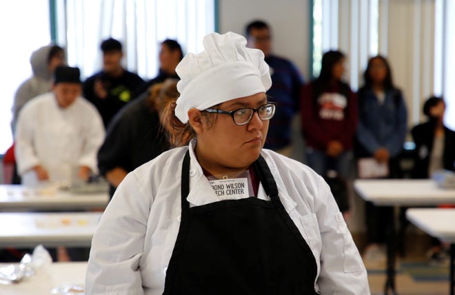 Bond Wilson Technical Center student Jaylynn Delgarito watches participants in the culinary arts competition at Skills Fest on Oct. 22 at Navajo Technical University in Crownpoint.