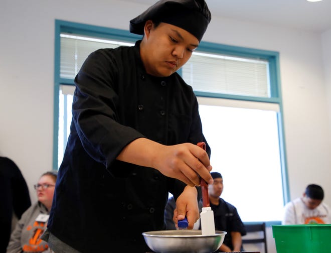 Miyamura High School student Maven Wilson cooks an omelet at the culinary arts competition for Skills Fest on Oct. 22 at Navajo Technical University in Crownpoint.