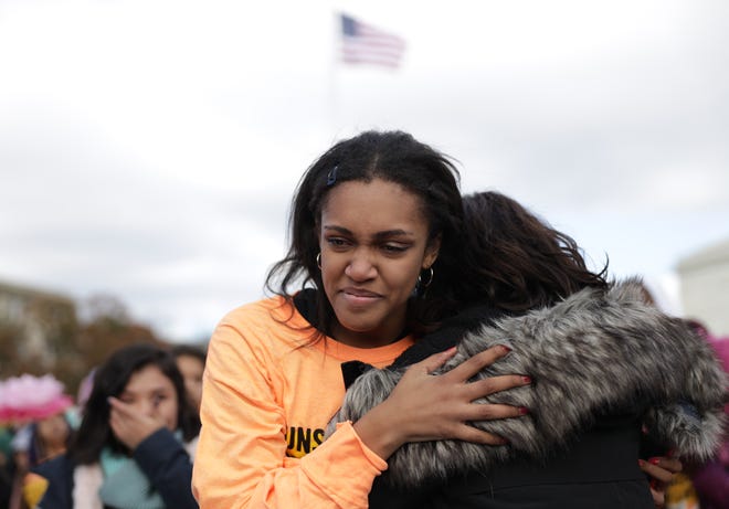 DACA student Lakshmi Mosquera is comforted by another student immigration activist after she told her story during a rally defending Deferred Action for Childhood Arrivals (DACA) in front of the U.S. Supreme Court after they walked out from area high schools and universities Nov. 8, 2019, in Washington.