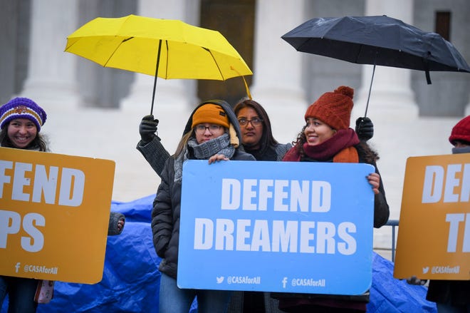 People stand in the cold and rain outside of the U.S. Supreme Court on Nov. 12, 2019 ahead of arguments on whether the 2017 Trump administration decision to end the Deferred Action for Childhood Arrivals program (DACA) is lawful.