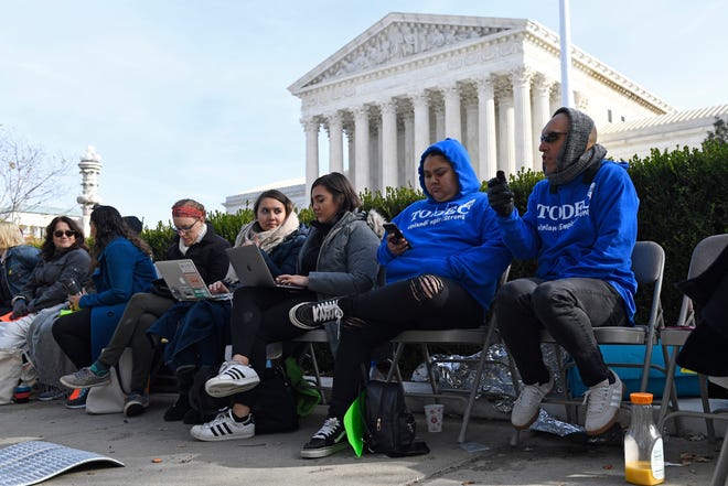 People wait in line outside the Supreme Court in Washington on Nov. 11, 2019, to be able to attend oral arguments.