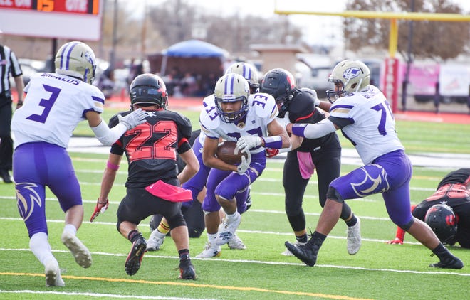 Kirtland Central's Zakk Thomas runs up the middle during Saturday's 4A state quarterfinals football game at Grants.