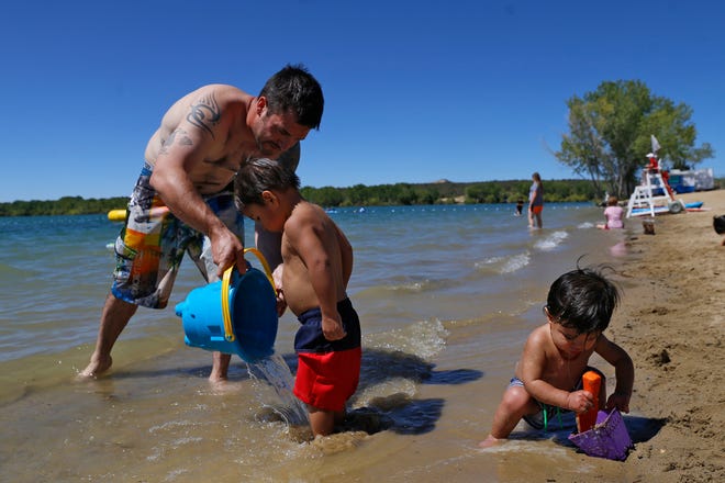 From left, Josh Vinzant plays with his children, Mason Vinzant and Mavrick Vinzant, Monday, Sept. 5, 2016 at The Beach at Lake Farmington.