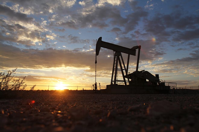A pump jack is seen in September 2012 off Road 6480 during sunset.